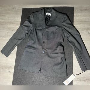 Calvin Klein professional suit jacket with logo buttons on long sleeves.